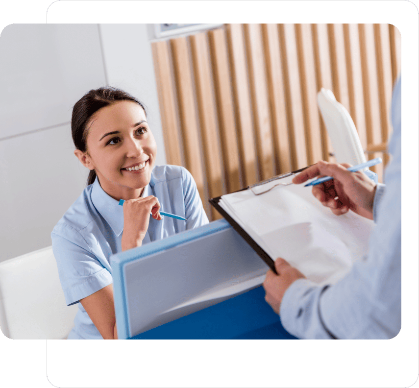 A dental receptionist taking information from another colleague, Fill-ins Locum Agency place receptionists across the South West